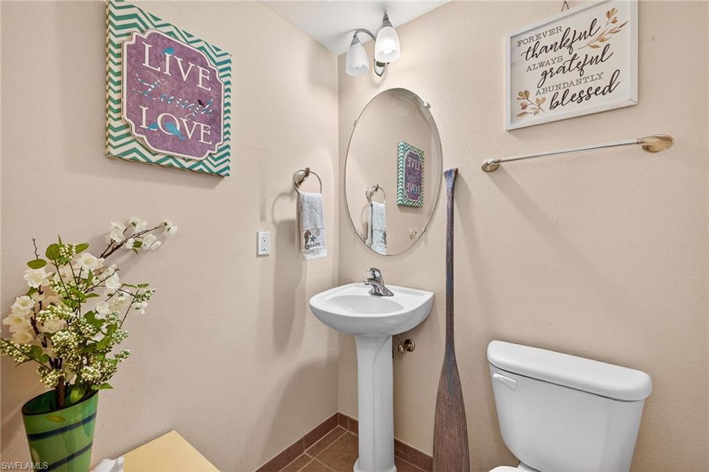 Bathroom featuring toilet and tile patterned flooring