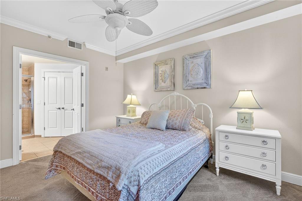 Bedroom with ornamental molding, carpet floors, and a ceiling fan