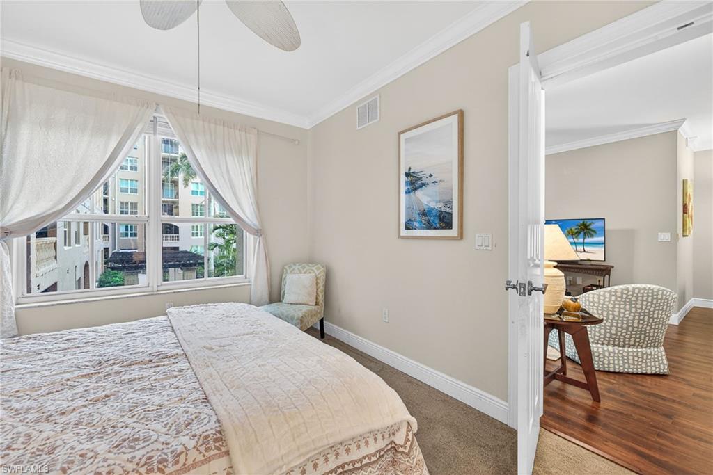 Bedroom featuring ornamental molding, a ceiling fan, and wood finished floors