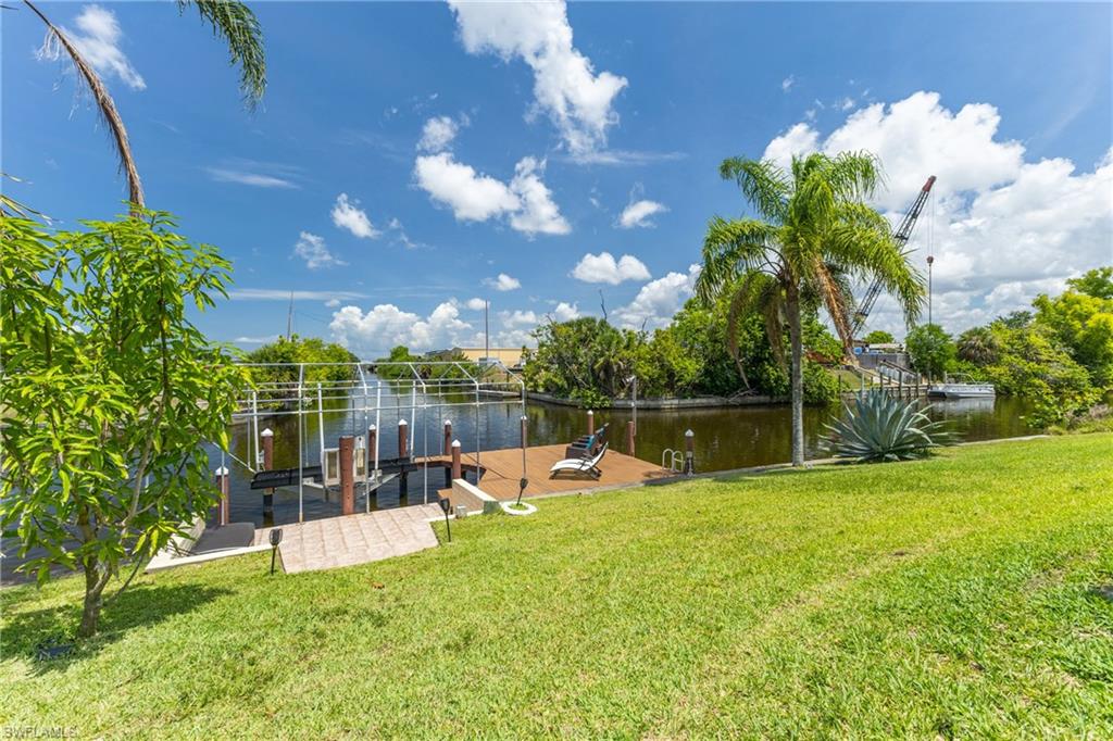 Dock with a yard and a water view