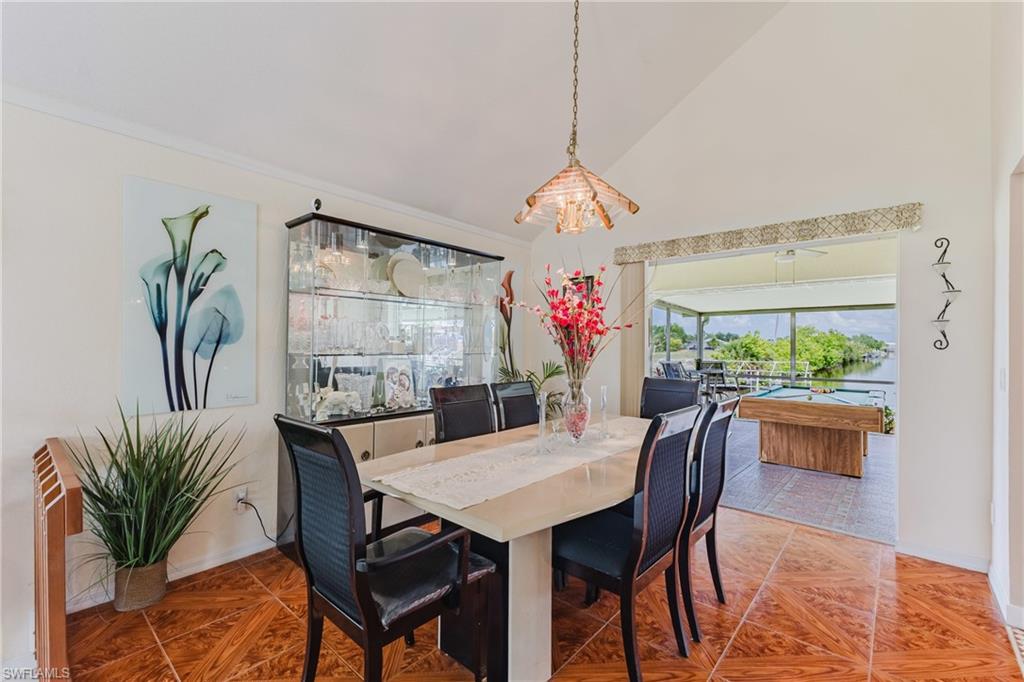 Dining room with vaulted ceiling and a chandelier