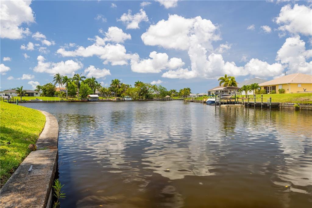 Water view with a boat dock and nearby suburban area