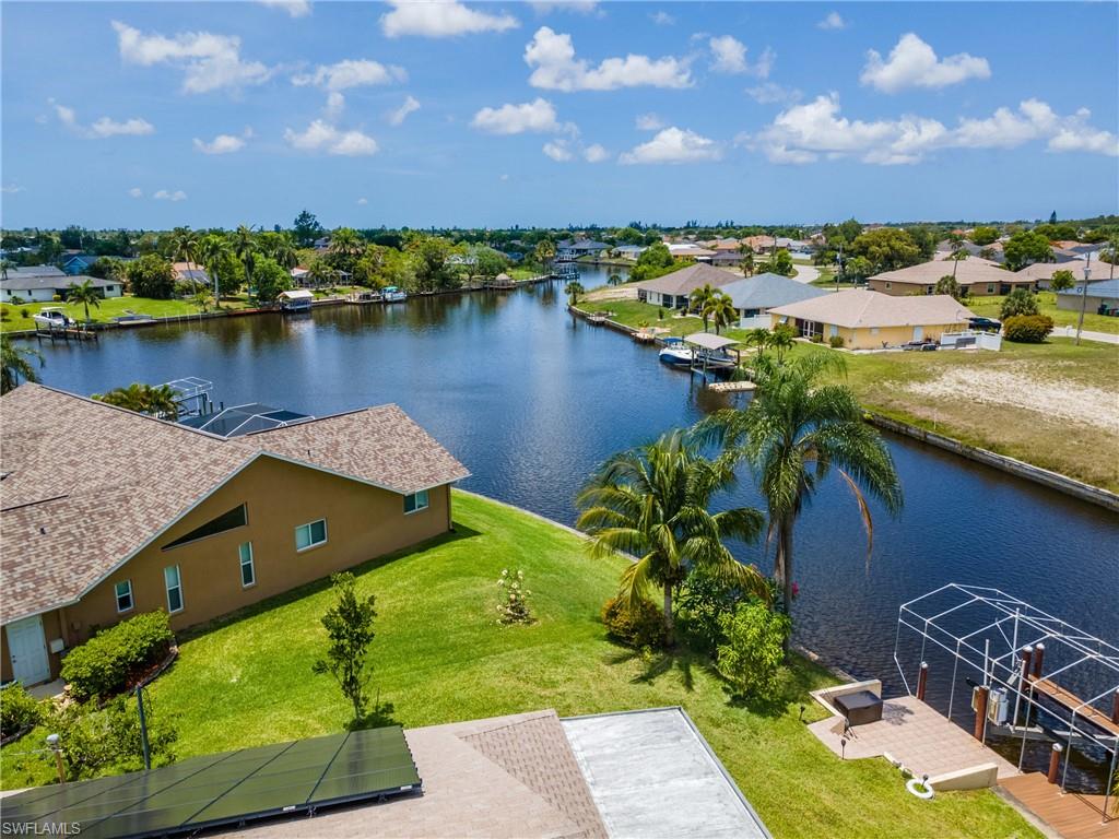 Aerial view of residential area featuring a nearby body of water