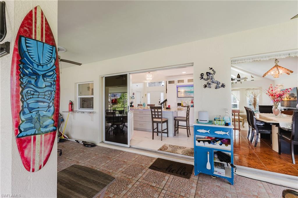 Property entrance with ceiling fan and outdoor dining space