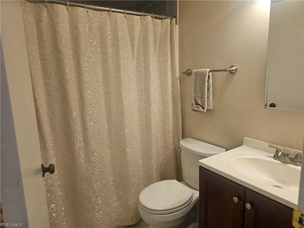 Full bath with vanity and a shower with curtain