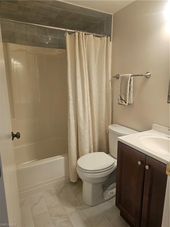 Full guest bath featuring vanity and shower / bathtub combination with curtain