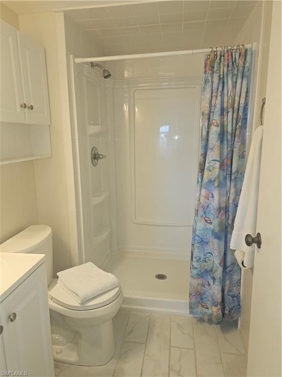 Full bath with a shower stall and vanity