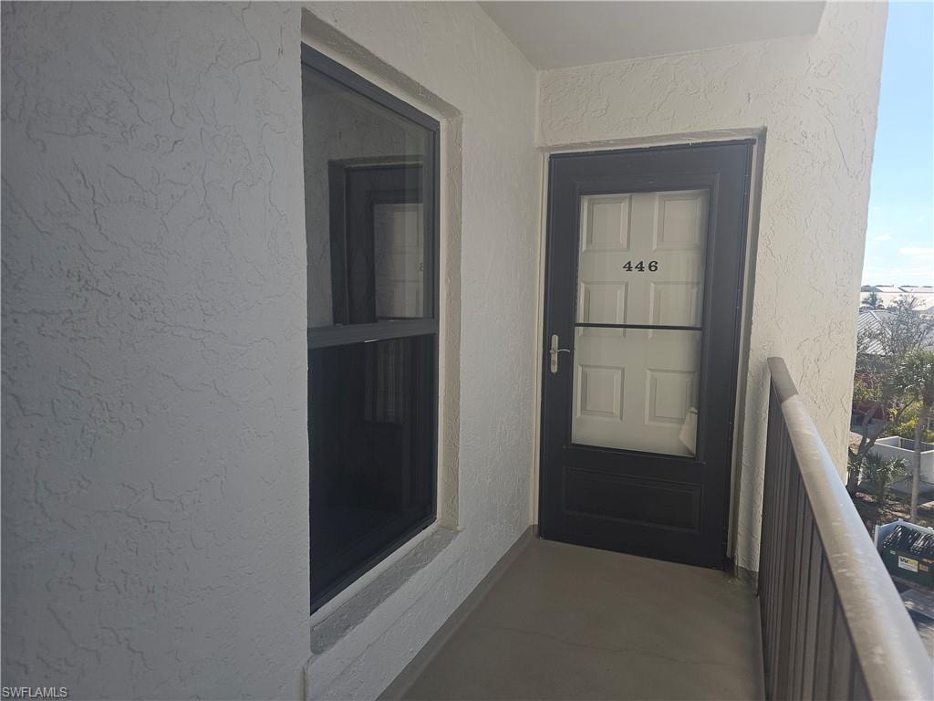 Entrance to property with stucco siding