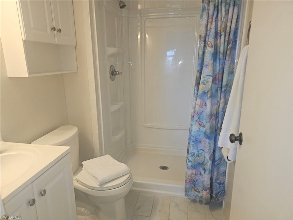 Bathroom with a stall shower and vanity