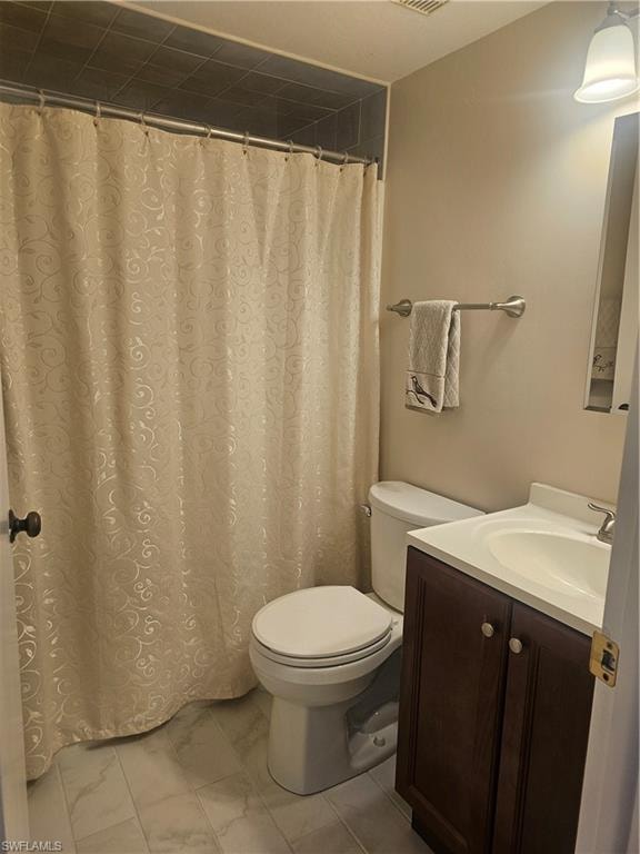 Full bath featuring vanity and curtained shower