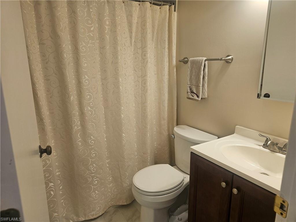 Bathroom featuring vanity and curtained shower