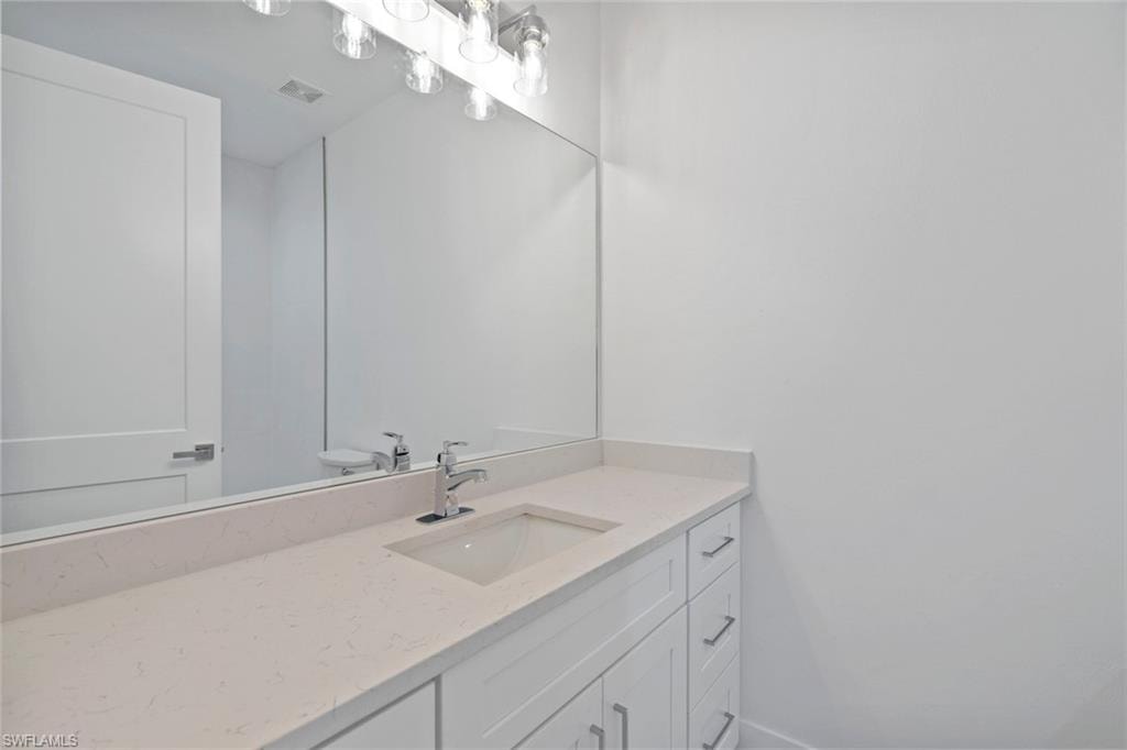 Bathroom with visible vents and vanity