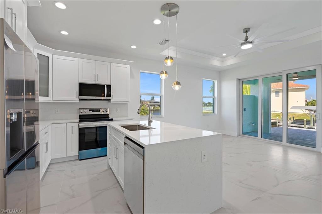 Kitchen featuring marble finish floor, visible vents, a sink, and appliances with stainless steel finishes