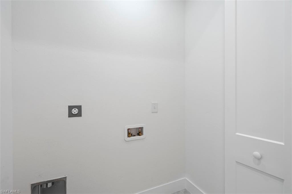 Laundry area featuring hookup for a washing machine, baseboards, laundry area, and hookup for an electric dryer