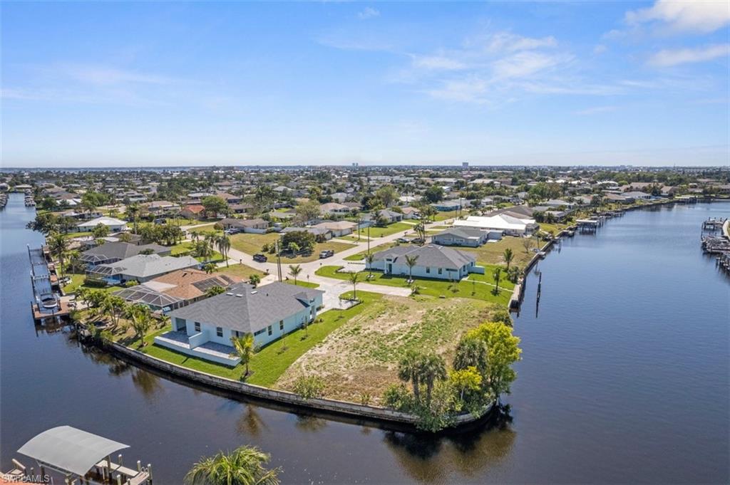 Drone / aerial view with a residential view and a water view