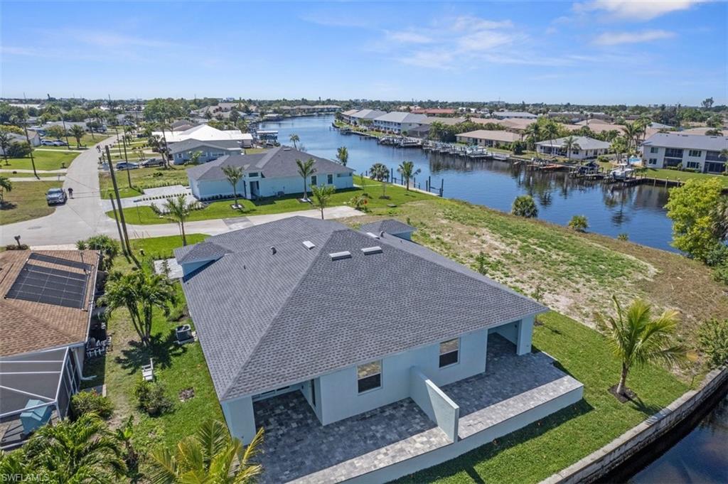Birds eye view of property featuring a water view and a residential view
