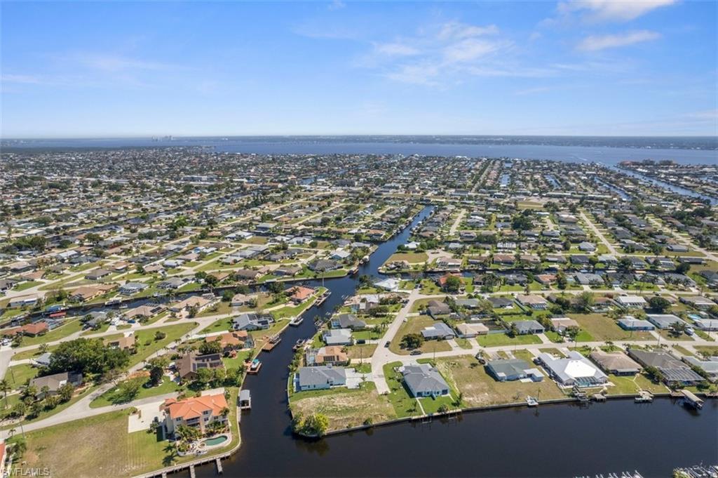 Aerial view featuring a residential view and a water view