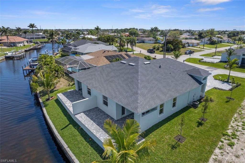 Aerial view featuring a residential view and a water view