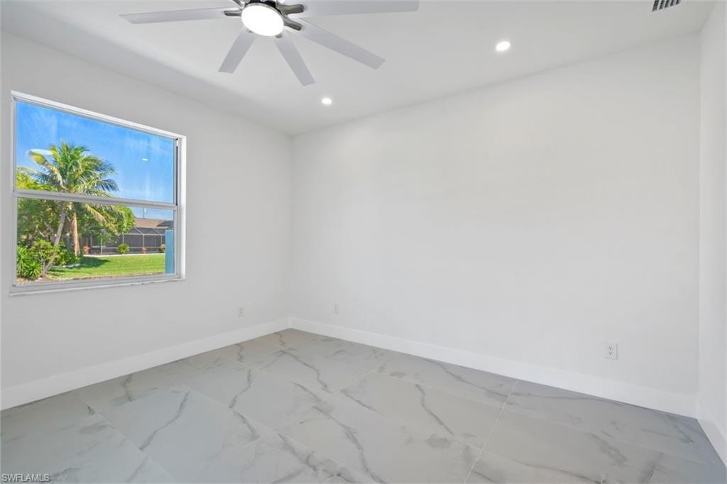 Spare room featuring marble finish floor, recessed lighting, baseboards, and ceiling fan
