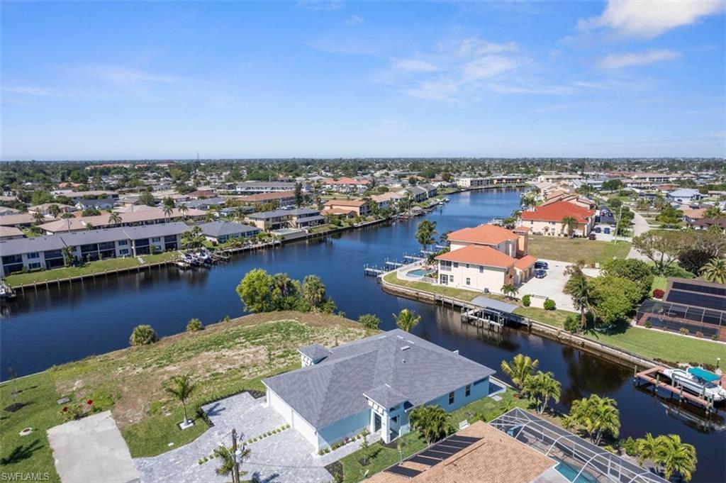 Birds eye view of property featuring a residential view and a water view