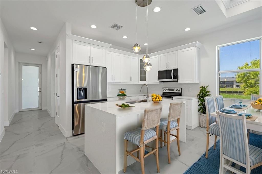 Kitchen with visible vents, a sink, recessed lighting, and appliances with stainless steel finishes