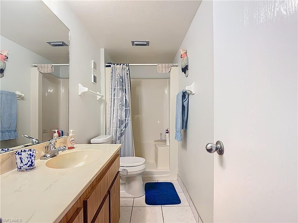 Master Bathroom featuring vanity, a shower with shower curtain, and light tile patterned floors