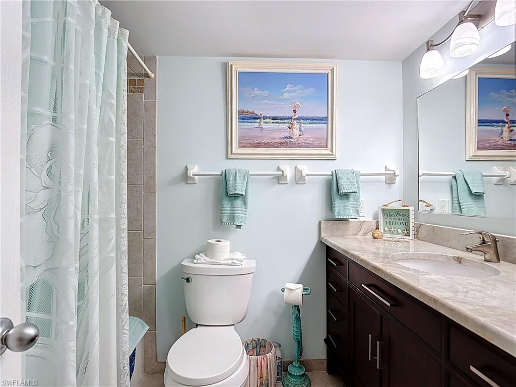 Full bath with vanity and curtained shower