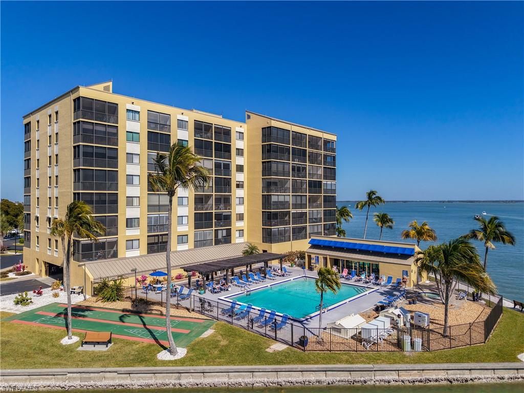 Community pool with a water view and a patio area