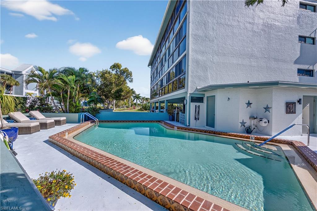 Condominium pool featuring a patio