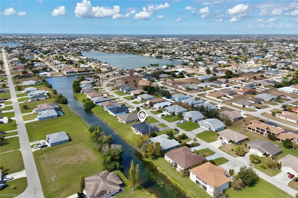 Aerial overview of property's location with a large body of water and nearby suburban area