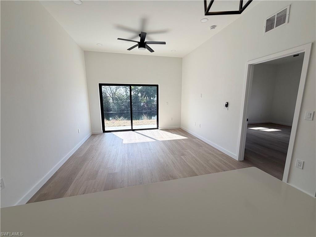 Unfurnished room with ceiling fan, light wood-type flooring, and recessed lighting