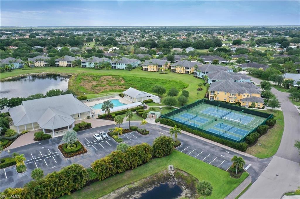 Aerial perspective of suburban area with a nearby body of water and a pool