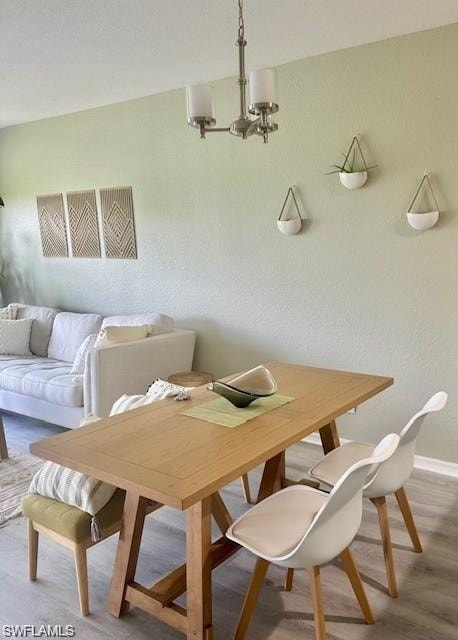 Dining room featuring light wood finished floors and suspended lighting