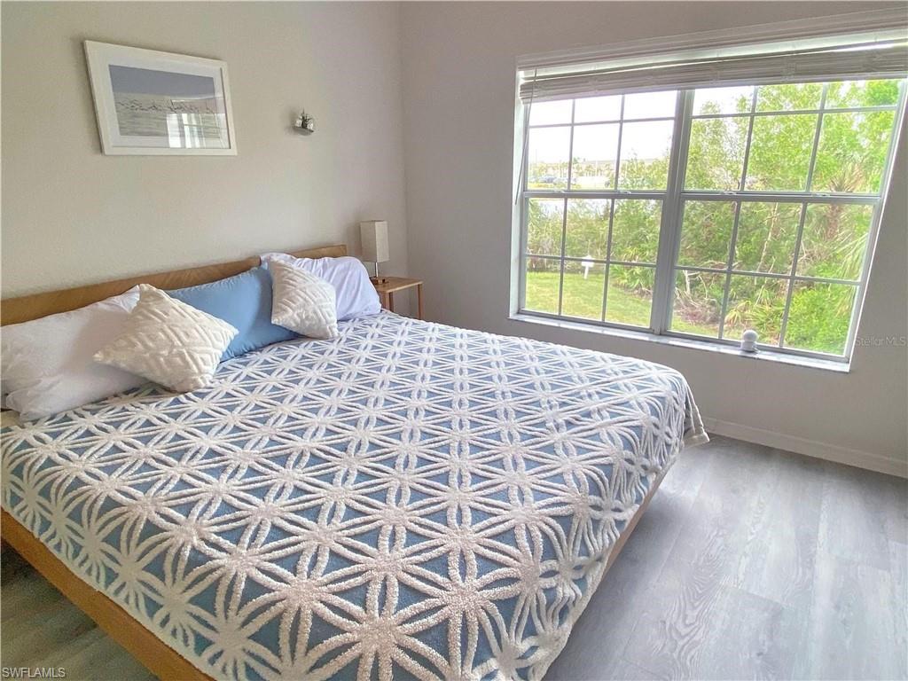 Bedroom with wood finished floors and baseboards