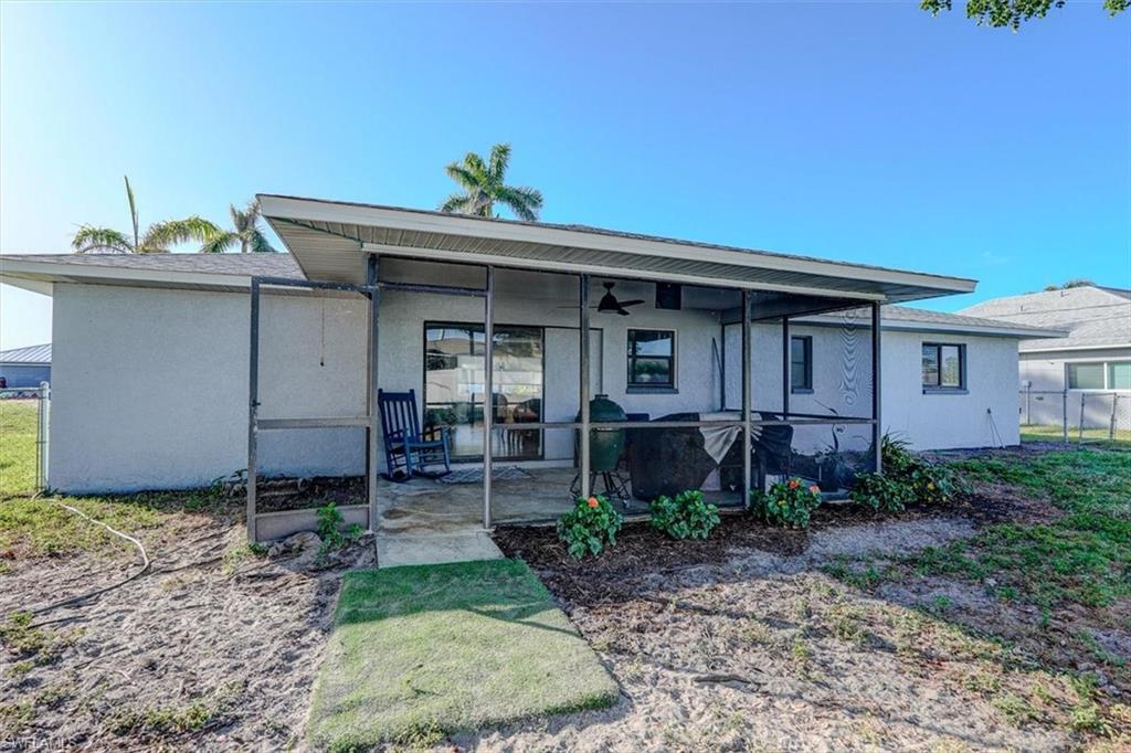Back of property featuring ceiling fan and a patio
