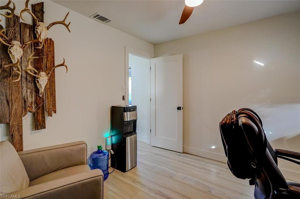 Office space featuring ceiling fan and light hardwood / wood-style flooring