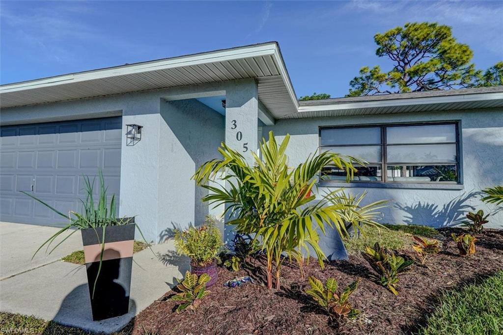 View of side of home featuring a garage