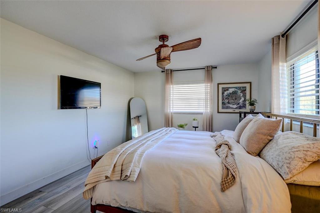 Bedroom featuring ceiling fan and light hardwood / wood-style flooring