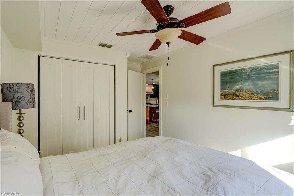 Unfurnished bedroom with ceiling fan, wooden ceiling, crown molding, and a closet