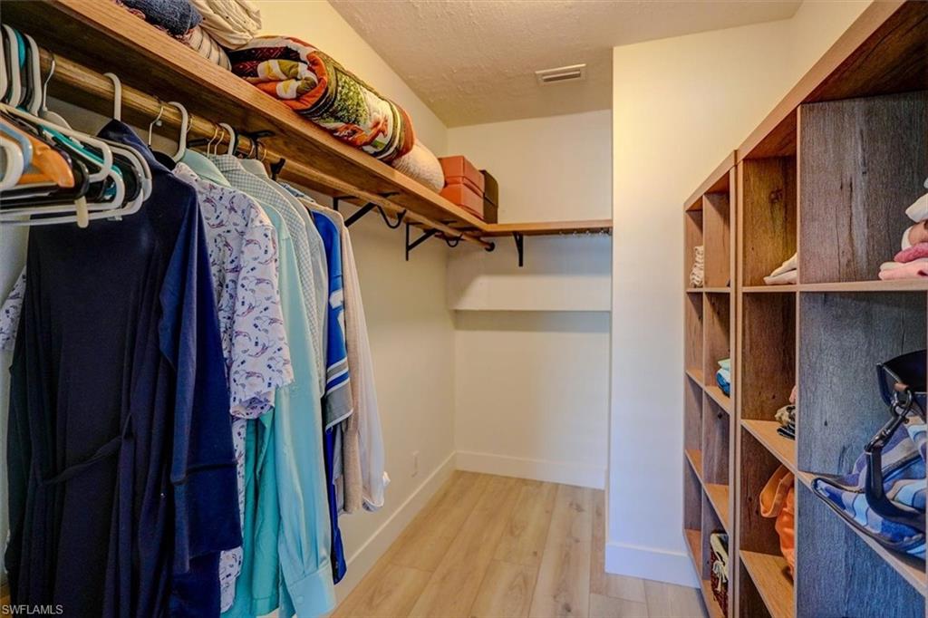 Spacious closet featuring light hardwood / wood-style floors