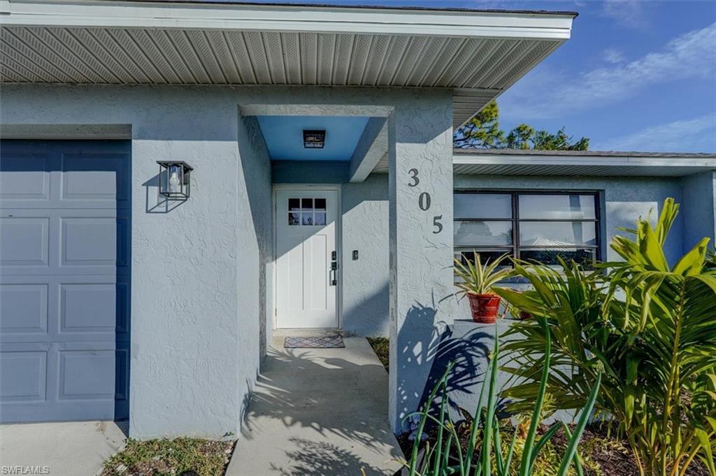 Doorway to property with a garage
