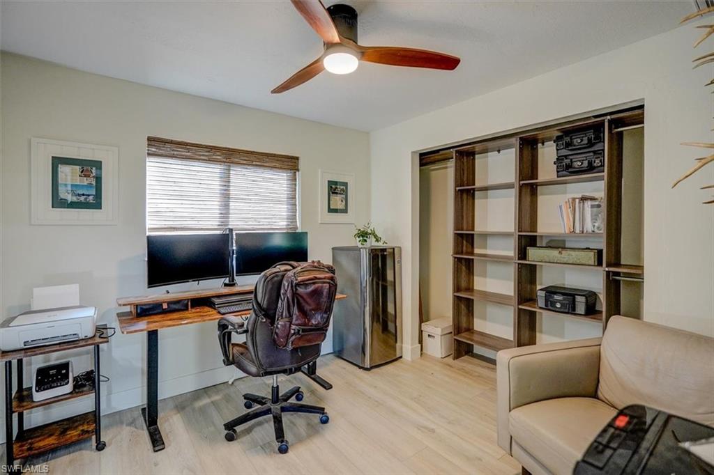 Office area featuring light hardwood / wood-style floors and ceiling fan