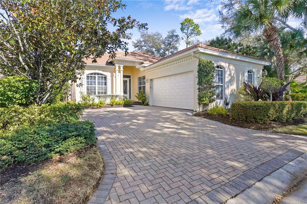 Mediterranean / spanish home featuring stucco siding, decorative driveway, and an attached garage