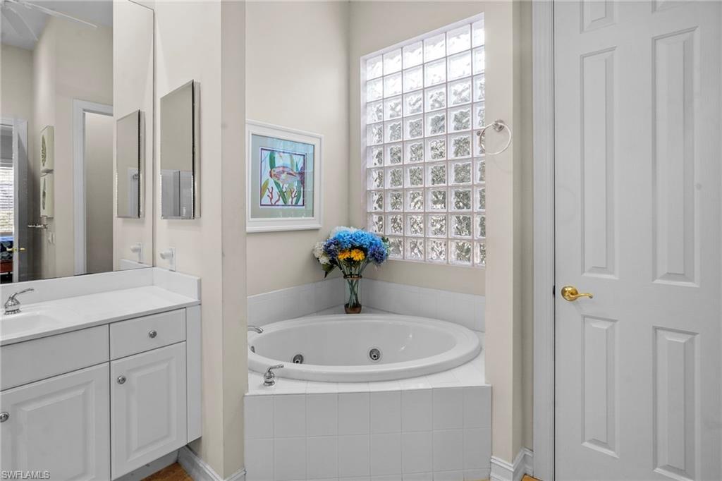 Bathroom with a jetted tub and vanity