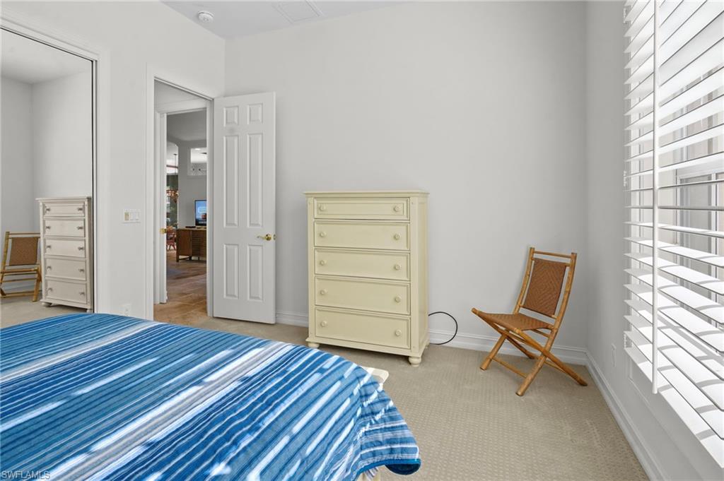 Bedroom with light carpet and baseboards