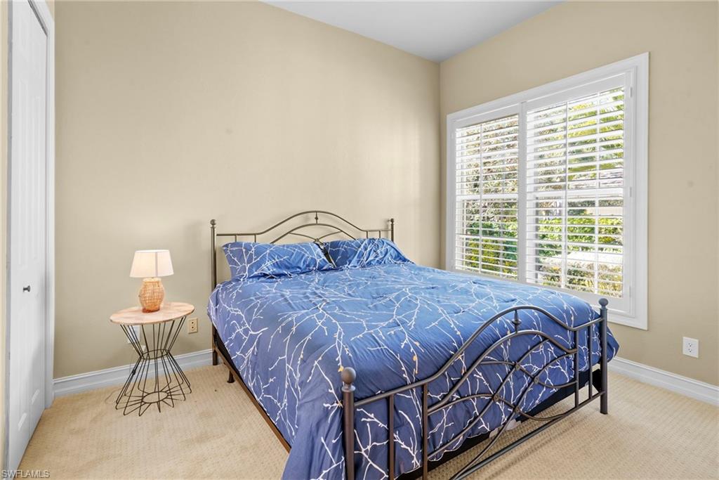 Carpeted bedroom featuring a closet and baseboards
