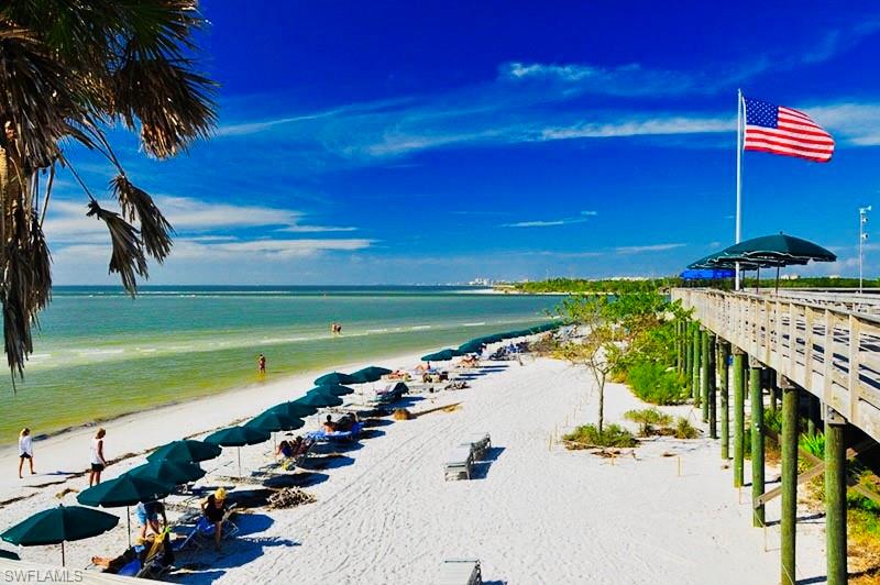 Water view featuring nearby beach and a pier