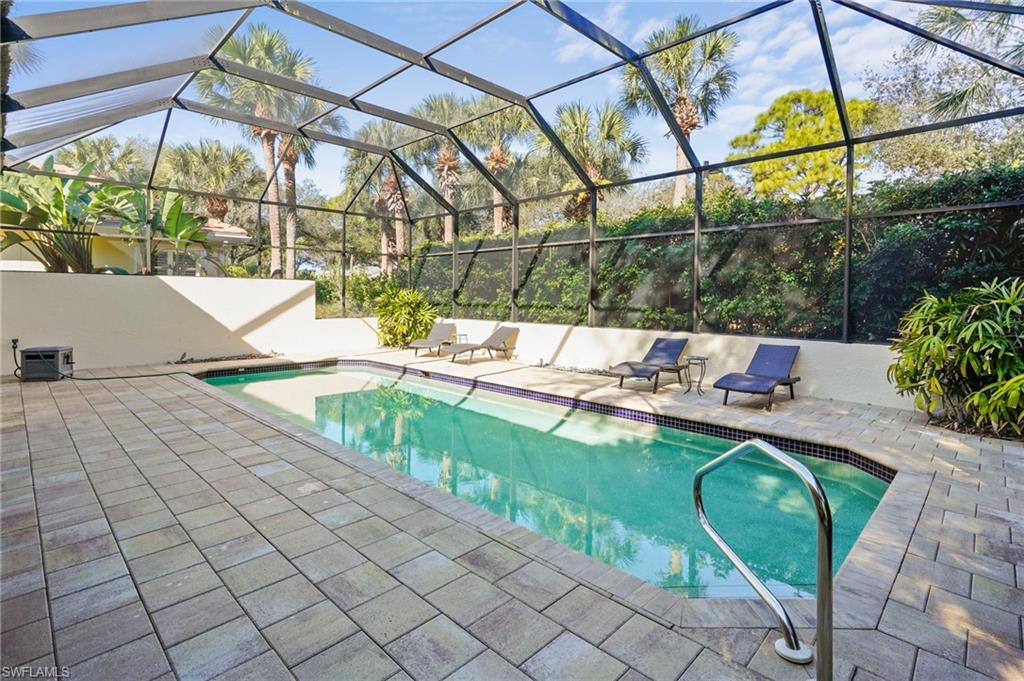 Outdoor pool with a lanai, a sunroom, and a patio