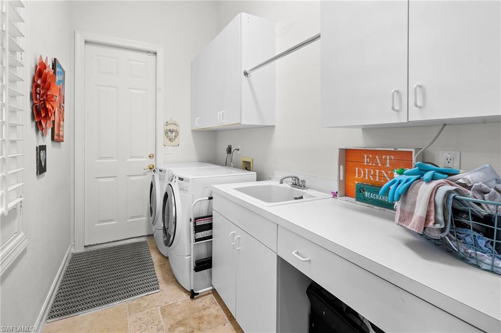 Laundry area with cabinet space and separate washer and dryer