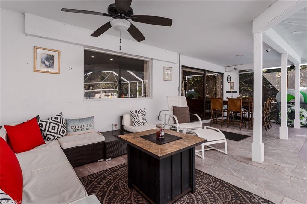 View of patio / terrace with a ceiling fan and outdoor living / dining area